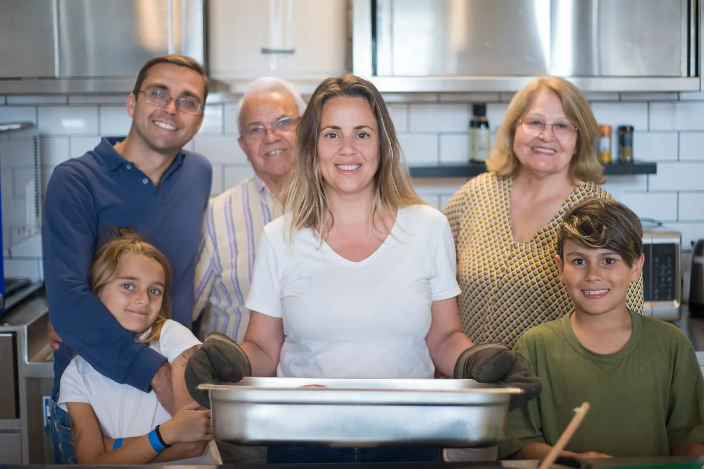 Smiling family with kids together in a bright kitchen