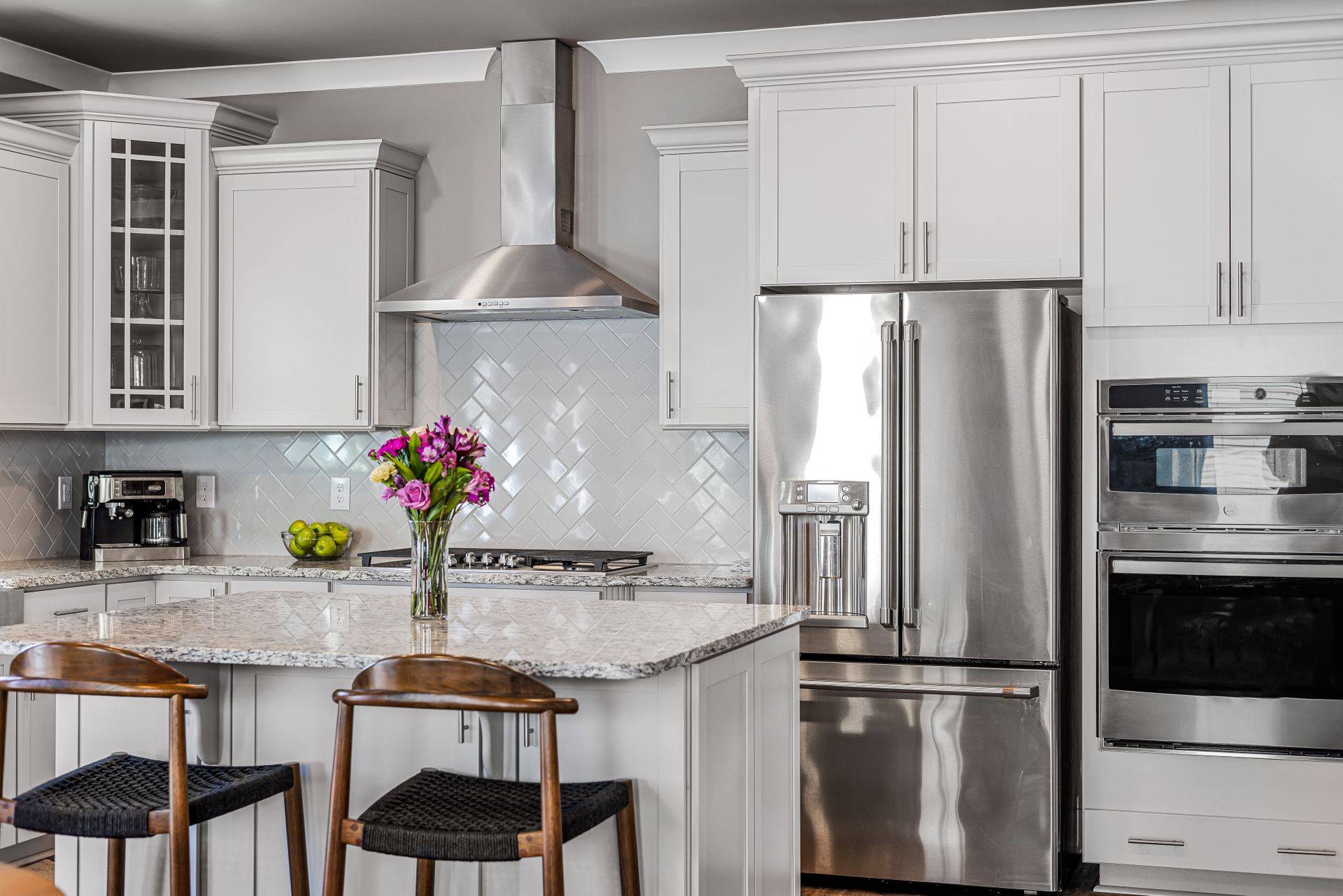 Kitchen with refrigerator, wall ovens and range