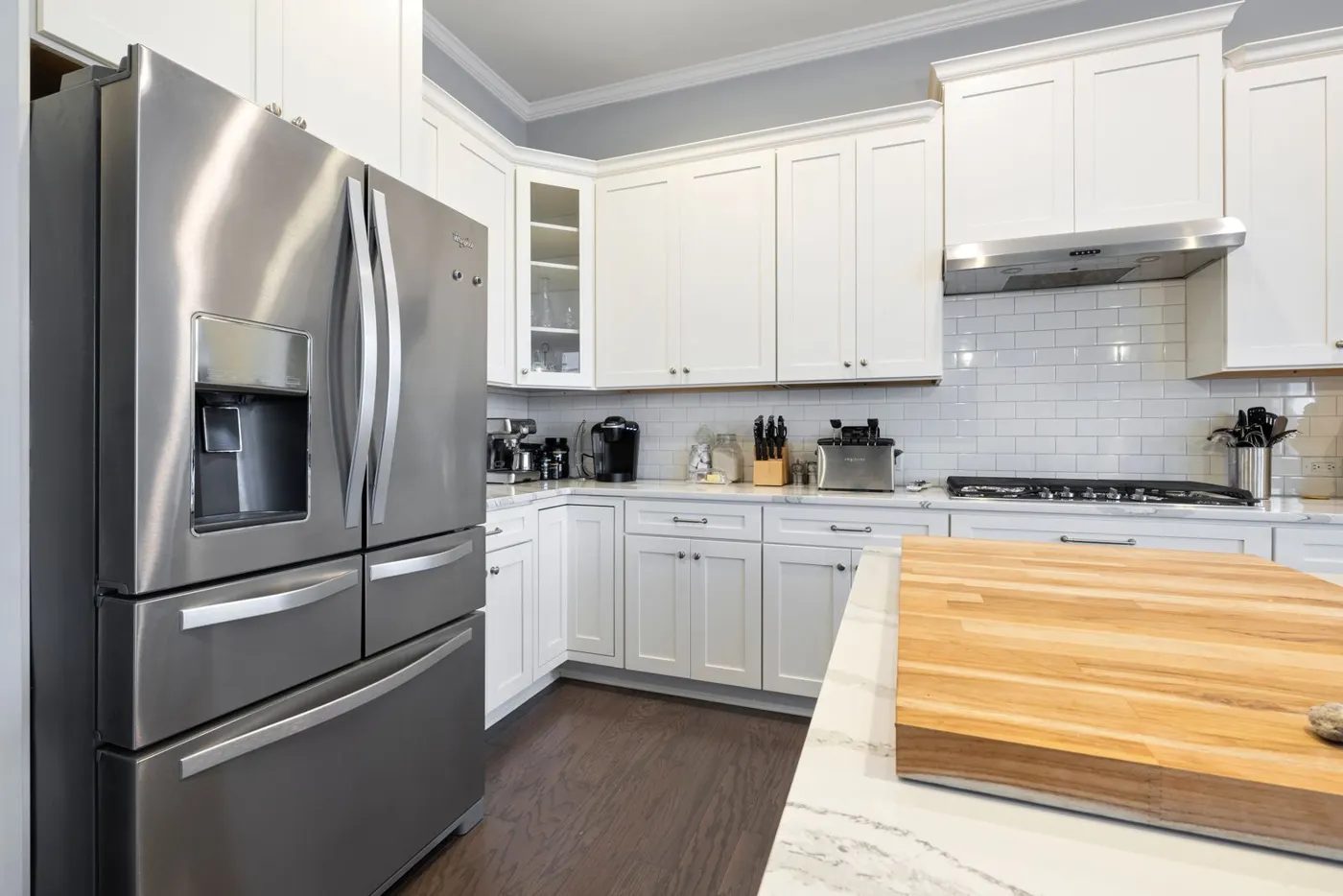 Stainless French-door refrigerator in a white kitchen