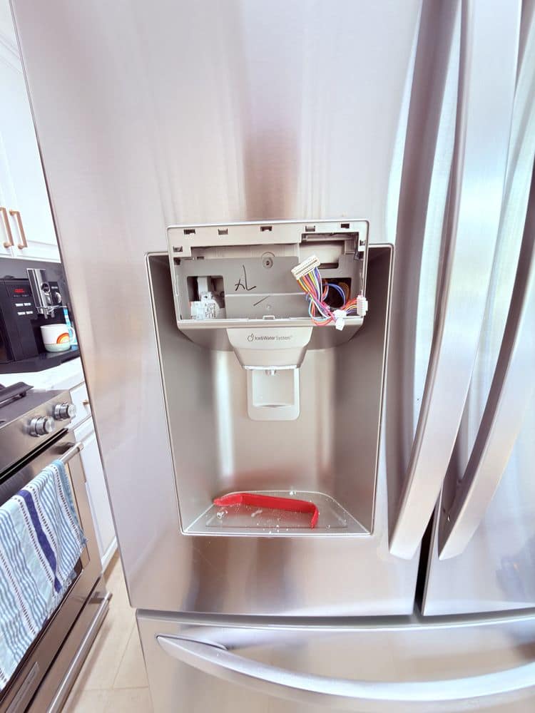 Refrigerator water dispenser panel repair on a French-door fridge