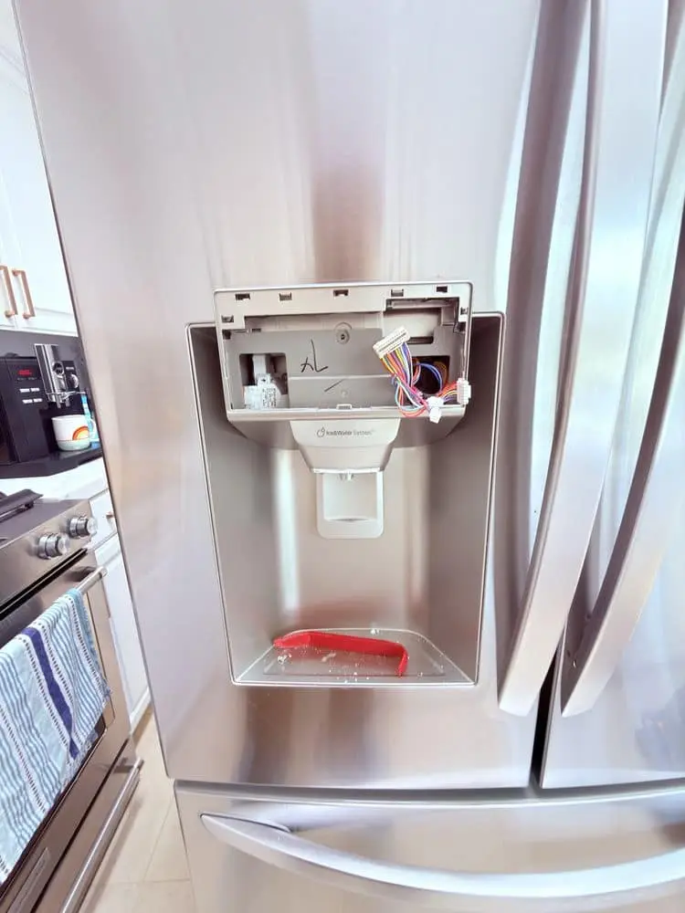 Refrigerator water dispenser panel repair on a French-door fridge