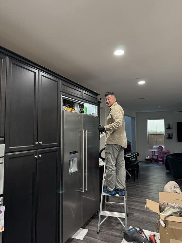 Built-in refrigerator repair — Alpha & Omega technician Tommy on the job