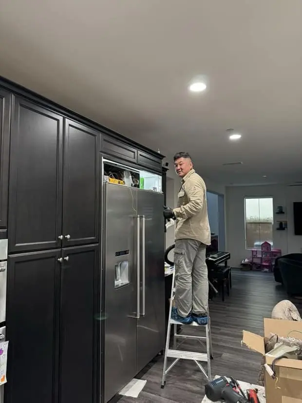 Built-in refrigerator repair — Alpha & Omega technician Tommy on the job