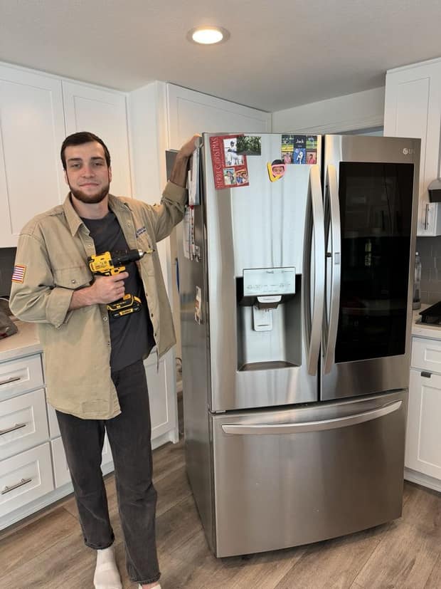 Alpha & Omega technician Adam fixing an LG refrigerator