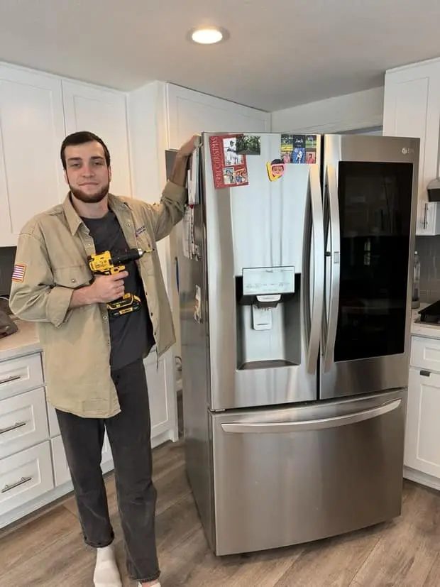 Alpha & Omega technician Adam fixing an LG refrigerator