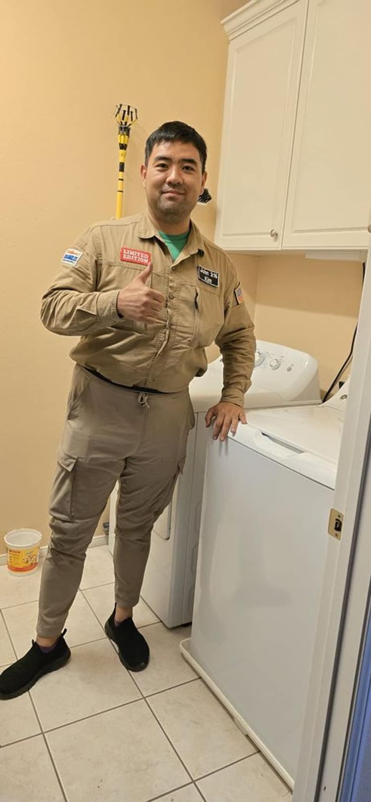 Alpha & Omega technician finishing a top-load washer repair